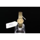A lady's gold plated Omega De Ville watch with manual,