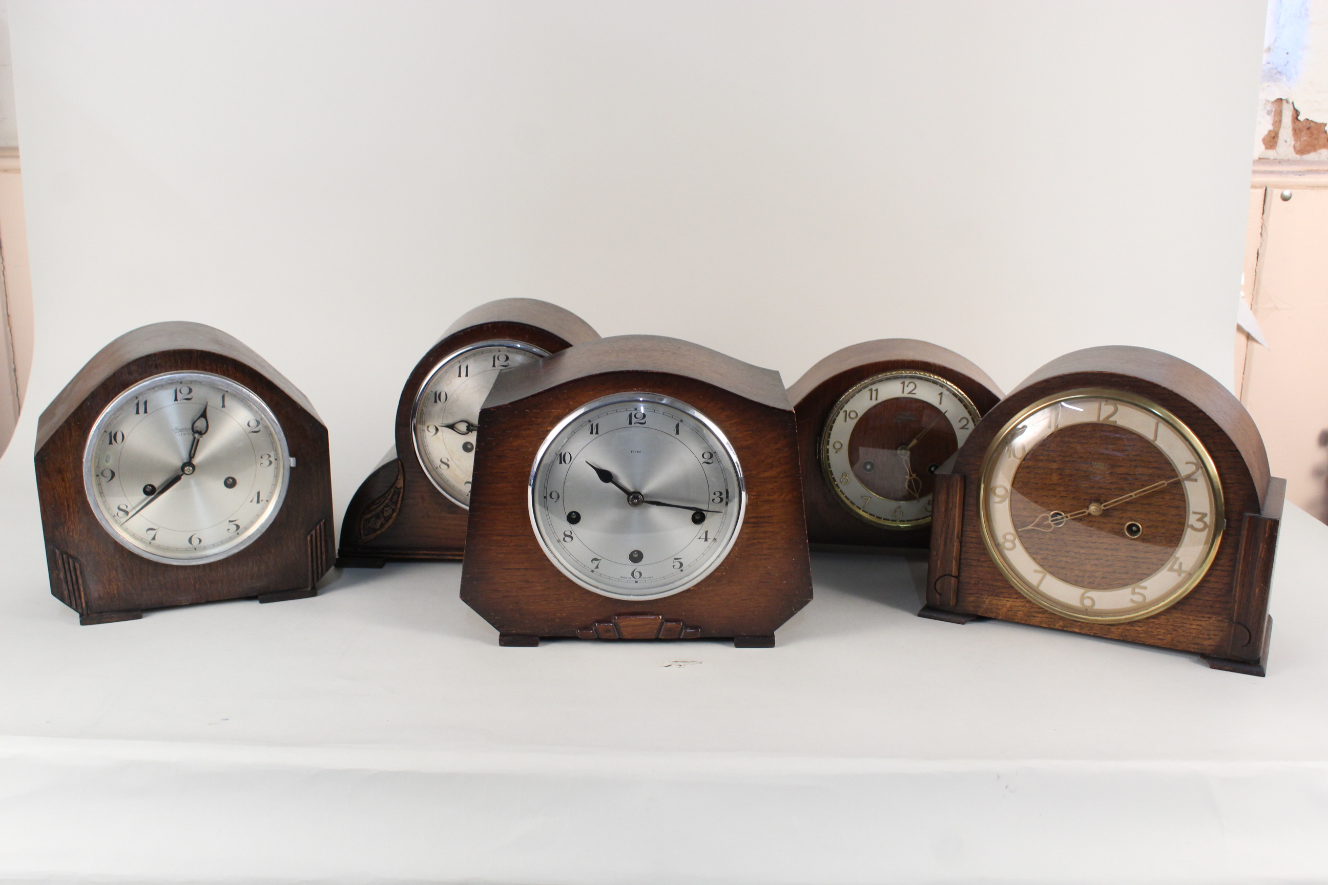 Five assorted oak cased 1950's mantel clocks