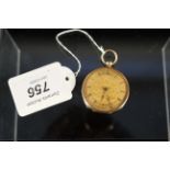 An 18ct gold engraved fob watch with base metal dust cover (missing glass)
