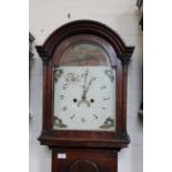 An early 19th Century mahogany arch dial cottage long case clock with painted face,