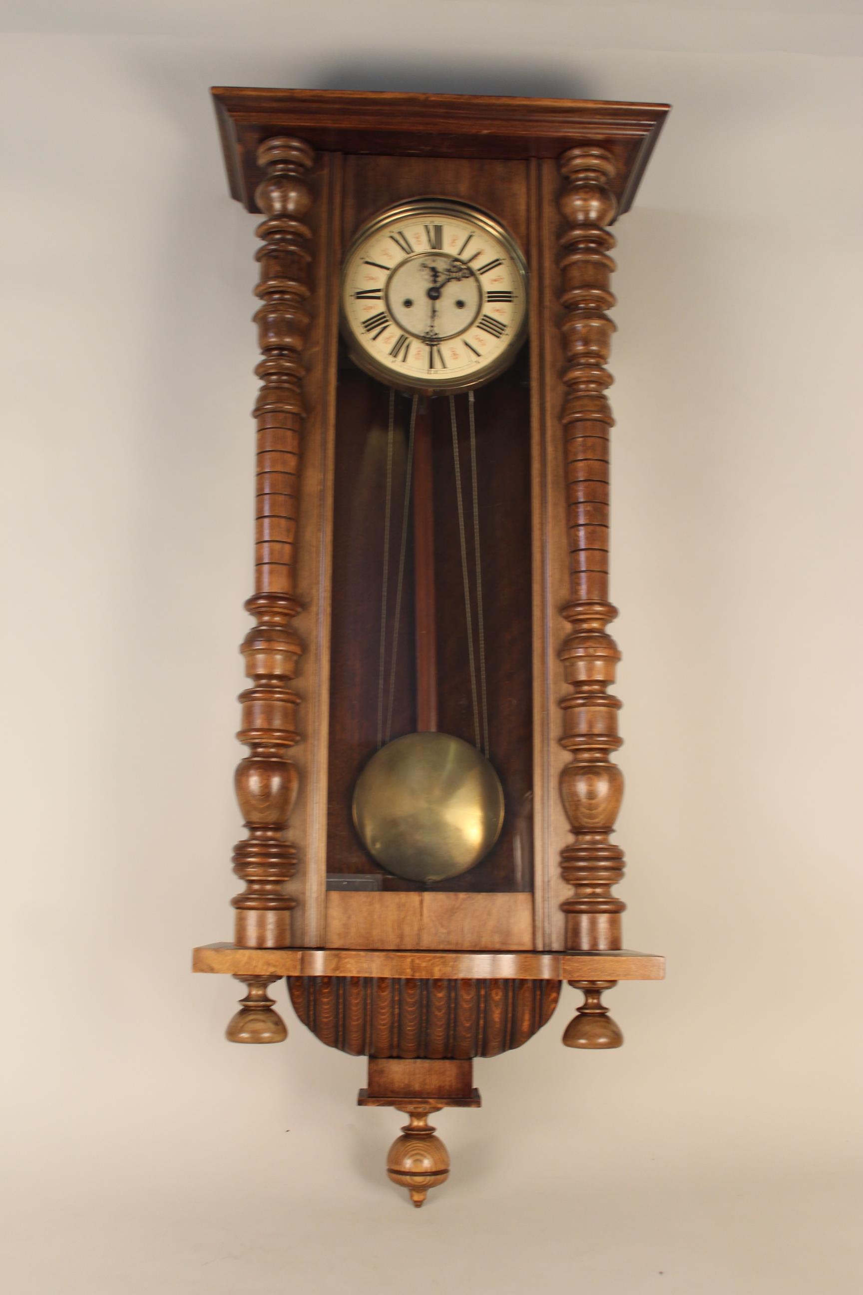 An Edwardian walnut cased Vienna wall clock by Gustav Becker