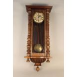 An Edwardian walnut cased Vienna wall clock by Gustav Becker