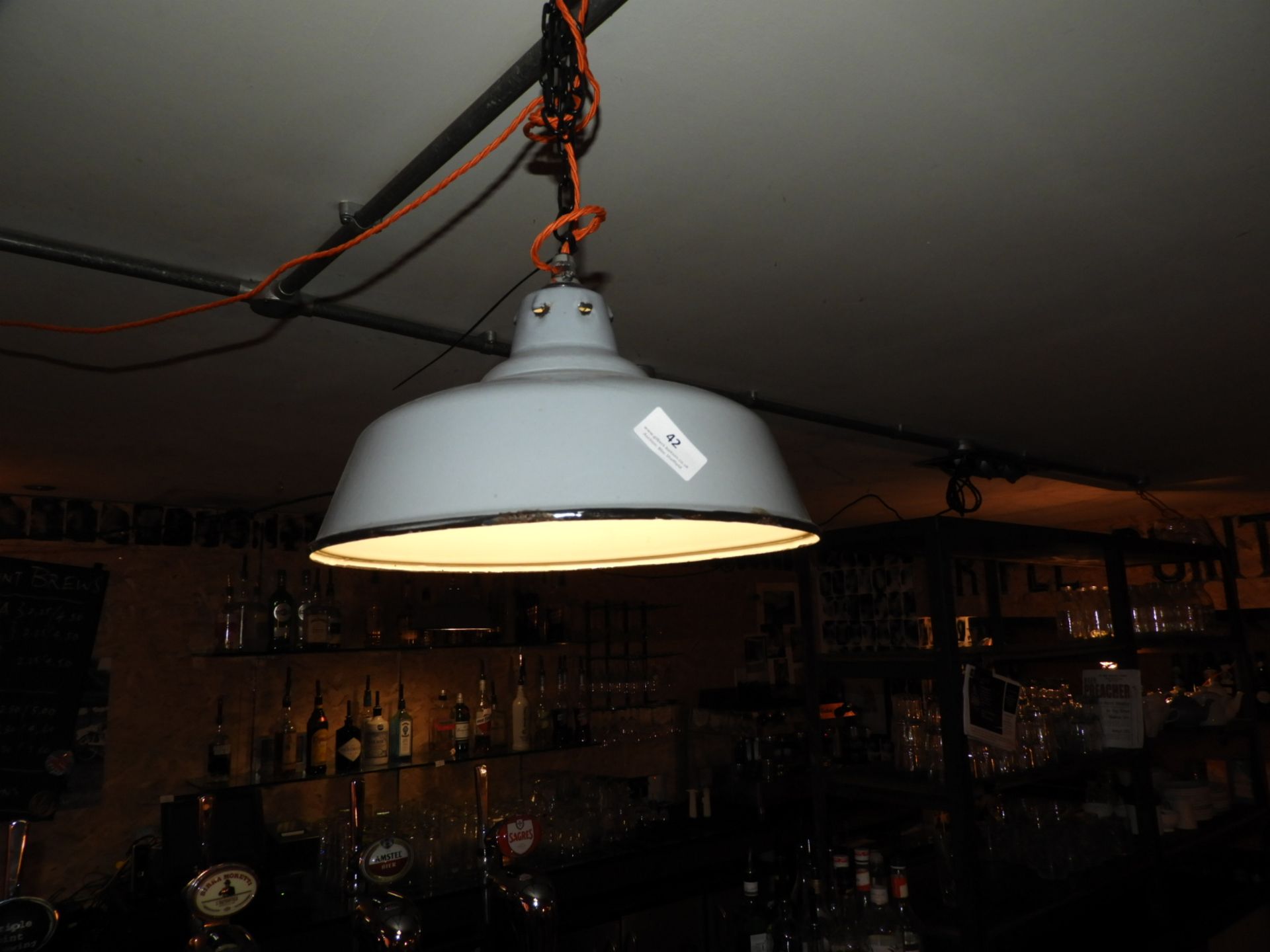 *Three Enamel Lamp Shades as Suspended over Bar Ar