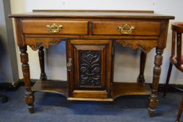 Edwardian Oak Hall Table on Turned Support with Drawers, Cupboard and Carved Panel