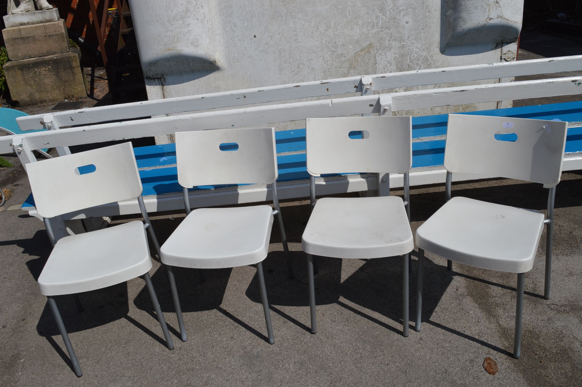 Four White Plastic Chairs