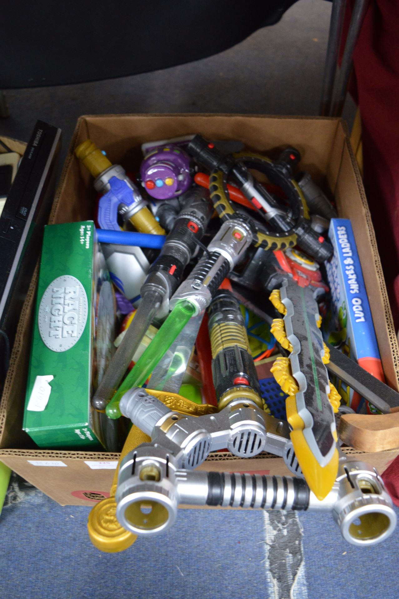 Box of Toys Including Swords, Lightsabers, etc.