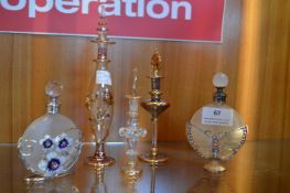 Five Glass Scent Bottles Including some Gold Plate