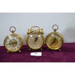 Three Ornate Continental Brass Alarm Clocks