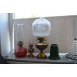 Three Oil Lamps and a Green Glass Shade