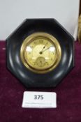 Small Brass Faced Clock in Octagonal Ebony Frame