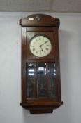 Oak Cased Pendulum Wall Clock with Beveled Glass Front