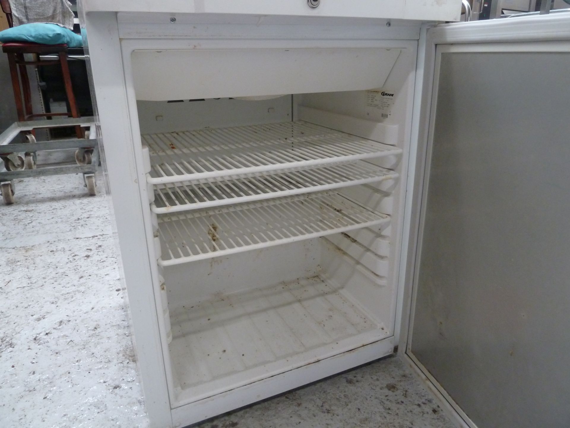 * white gram refrigerator, good condition, perfect for small kitchen.