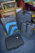 Two Grey Travel Cases and a Delsey Hardcase