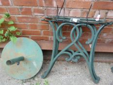 Pair of Cast Iron Table Ends and a Parasol Stand