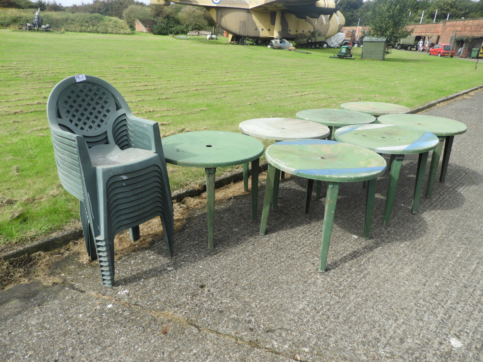 Nine Green Plastic Stackable Chairs and Seven Circular Tables