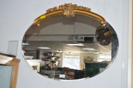 Beveled Edge Oval Wall Mirror with Ornate Gilt Decoration