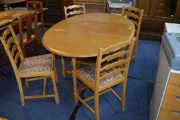 Light Oak Oval Topped Gate Leg Dining Table with Four Matching Chairs