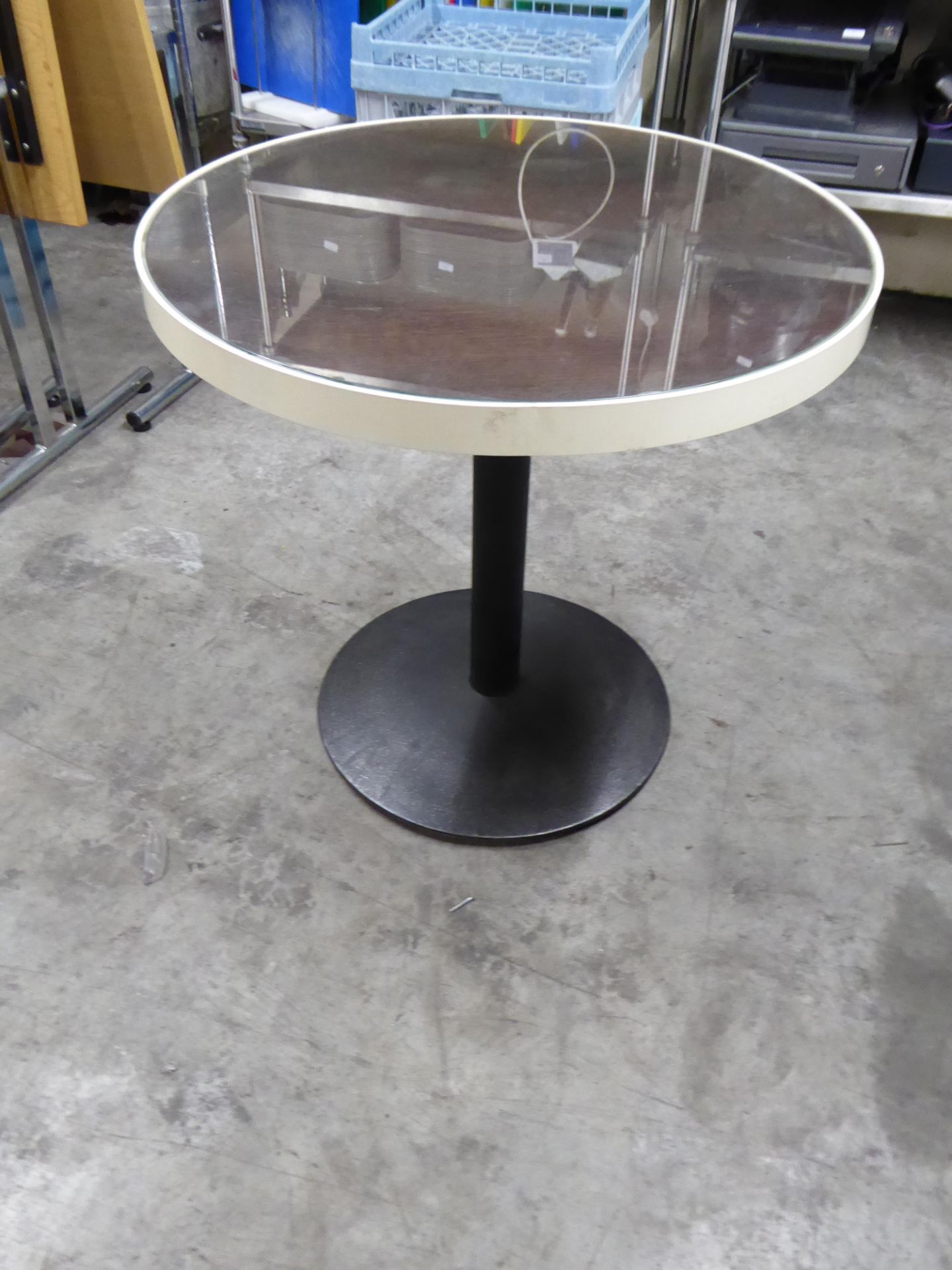 *round table with dark wood and glass tops with white trim and black pedestal bases x 2