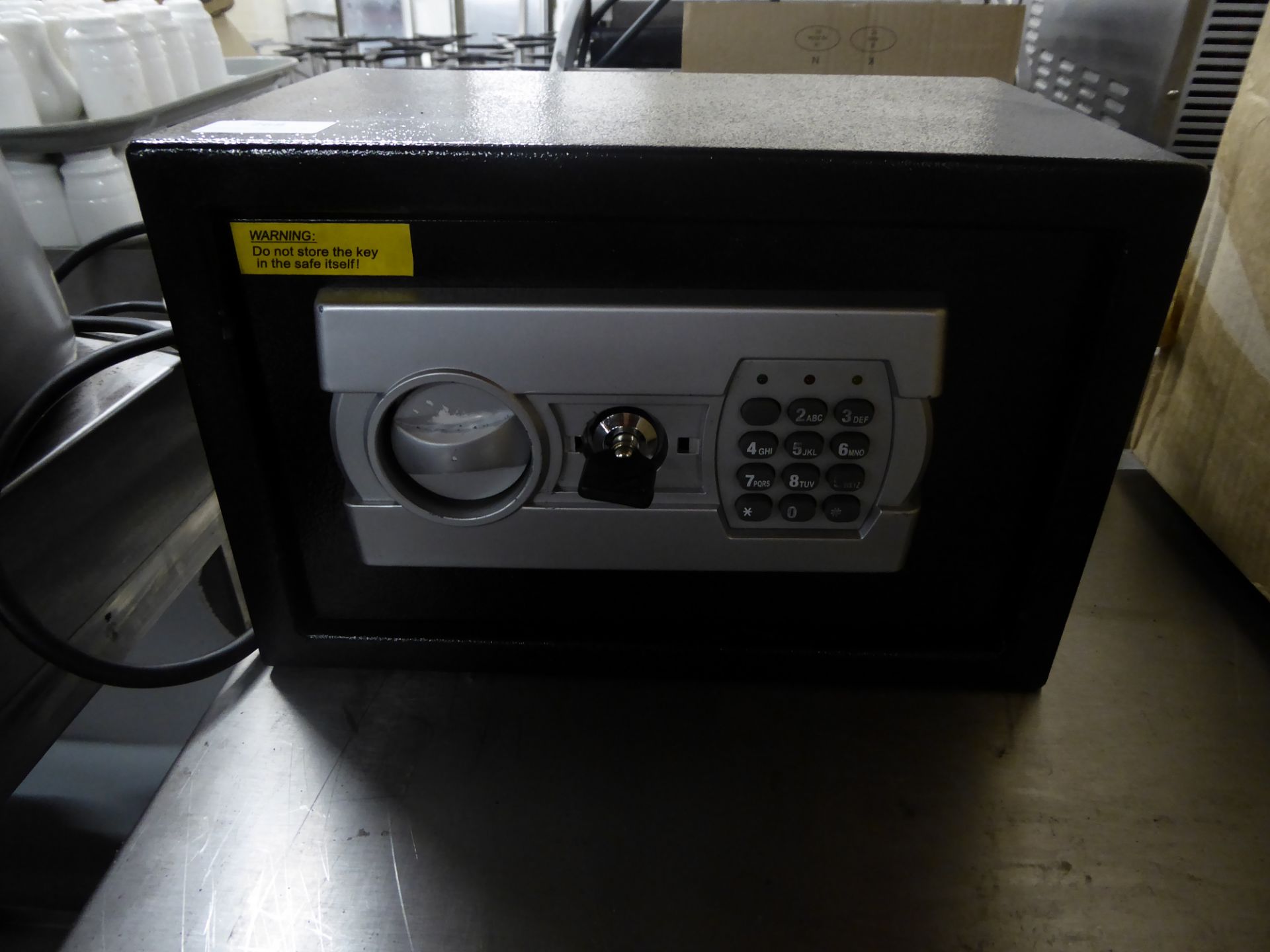 *small black safe with battery powered key pad and key