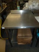 *S/S prep bench on castors with up stand and under shelf and cut outs on both sides 650w x 650d x