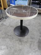 *round table with dark wood and glass tops with white trim and black pedestal bases x 2