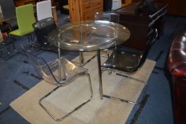 Circular Chrome Framed Glass Topped Table with Four Matching Perspex Chairs