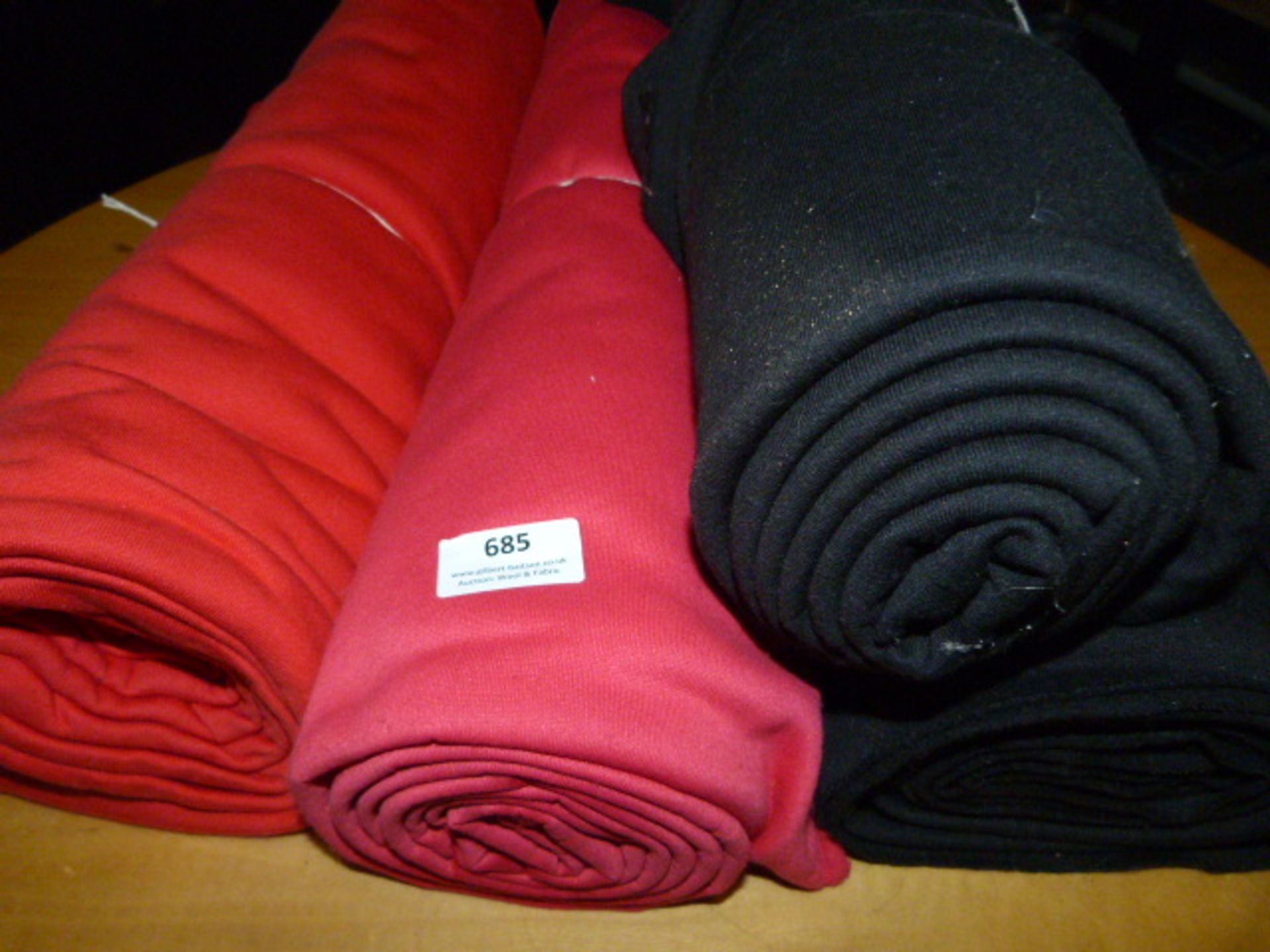 Four Small Rolls of Fabric (Black, Red & Pink)
