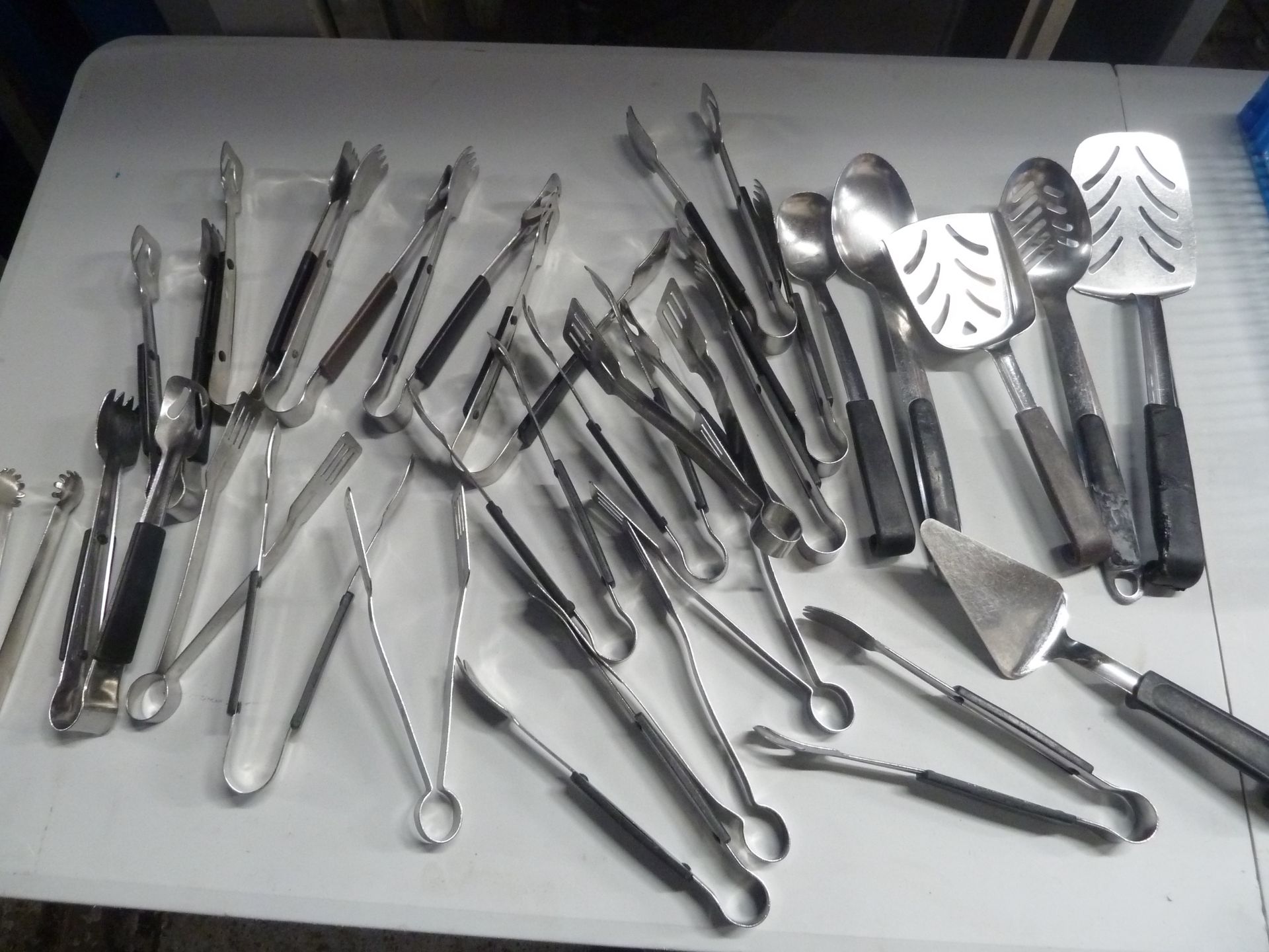 * selection of utensils - tongs, fish slices, spoons, scoops x approx. 25