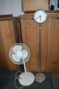 Honeywell Oscillating Fan and a Clock on a Stick