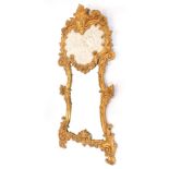 A Continental rococo style wall mirror, with floral and scrolling leaf moulding, set with a faux
