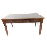 A Victorian oak desk, with gilt tooled green leather top, over three frieze drawers, raised on