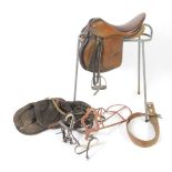 A two tone brown leather saddle, together with a metal saddle horse, and further tack. (qty)