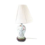 A Chinese famille rose porcelain table lamp, of baluster form with floral decoration against a