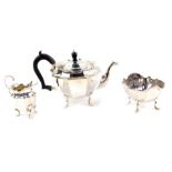 A George V silver three piece tea set, of fluted form, raised on four cabriole legs, comprising