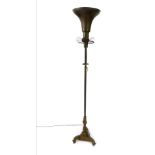 A Victorian and later brass uplighter, with a trumpet shaped shade and two side arm lights, raised
