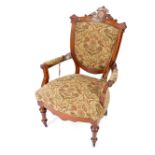 A Victorian walnut and burr walnut nursing chair, with a carved shield shaped back, upholstered in