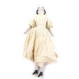 A Victorian porcelain doll, with a composite body, porcelain arms and legs, original dress, 52cm H.