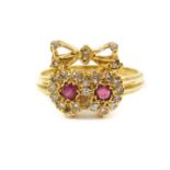 An 18ct ruby and diamond sweetheart ring, comprised of two conjoined hearts surmounted by a bow,
