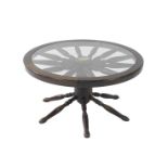 An oak capstan wheel type occasional table, inset glass top raised on a block column and six spindle