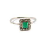 An emerald and diamond ring, the pyramid cut emerald in a surround of brilliant diamonds, in a