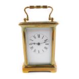 A French brass carriage clock, rectangular enamel dial bearing Roman numerals, single barrel