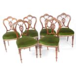 A set of six Victorian rosewood single dining chairs, with carved splat, overstuffed serpentine