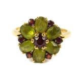 An 18ct gold peridot and garnet flower head ring, size M/N, 4.6g.