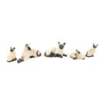 Four Beswick Siamese cats and kittens, in seated and recumbent pose, and a Siamese kitten pair. (5)