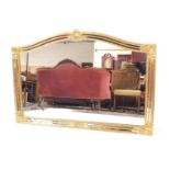 A gilt wood overmantel mirror, with moulded leaf detailing to the corners and top, 89cm H, 128cm W.