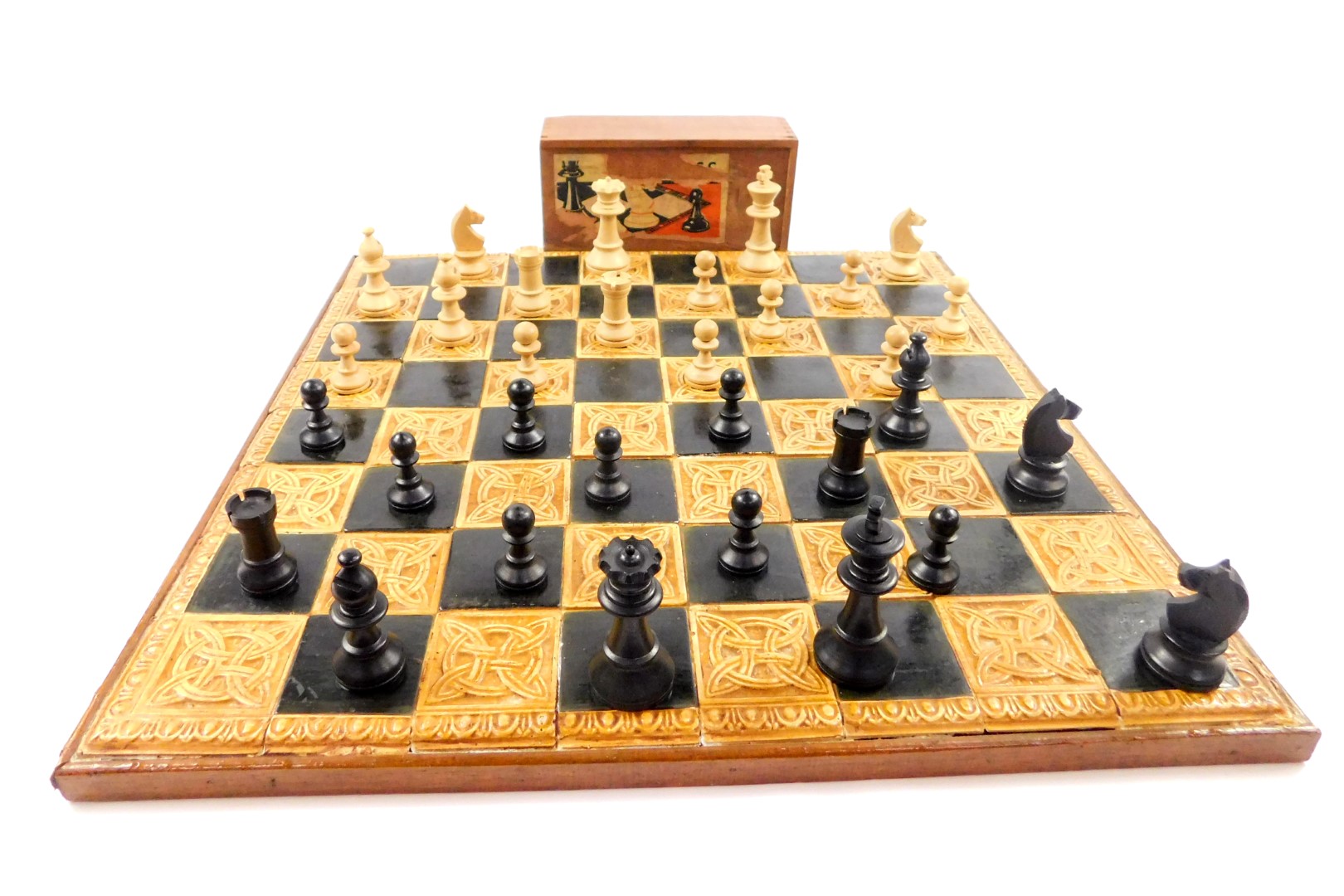 A Celtic style pottery chess board, 44cm dia, together with a Staunton type chess set (2)