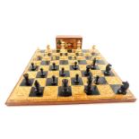 A Celtic style pottery chess board, 44cm dia, together with a Staunton type chess set (2)