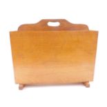 An Art Deco oak magazine rack, of rectangular, tapering twin division form, raised on block feet,