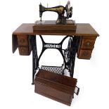A Singer table sewing machine, with a cast iron frame, table 104cm H (including sewing machine