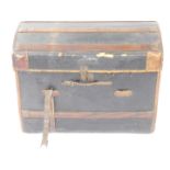 A Victorian leather and wooden bound domed trunk, with leather carrying handles, initialled to